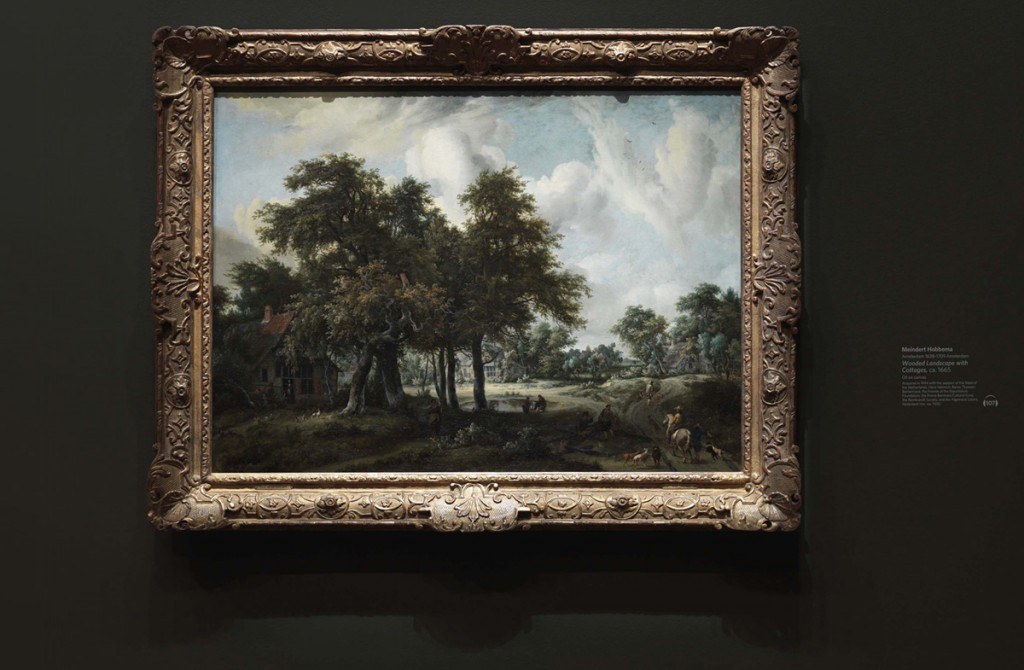 Museum wall labels using dry transfers. A landscape painting by Meindert Hobberma in the deYoung gallery showing the artwork label.