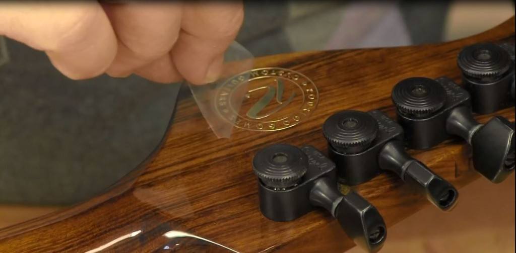 A closeup videocap of a metallic transfer foil applied on a custom guitar in a video from Stewart-MacDonald guitars and string instruments