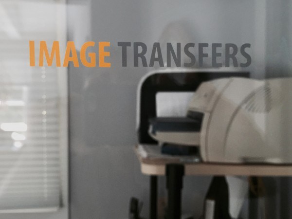The image transfers logo applied as a custom dry transfer to a interior glass door. Rub-on transfers can be used for corporate branding on glass.