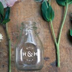 a product shot of a glass bottle with custom dry transfers