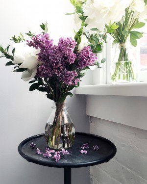 Product photo of flowers in a glass bottle by half and half flowers