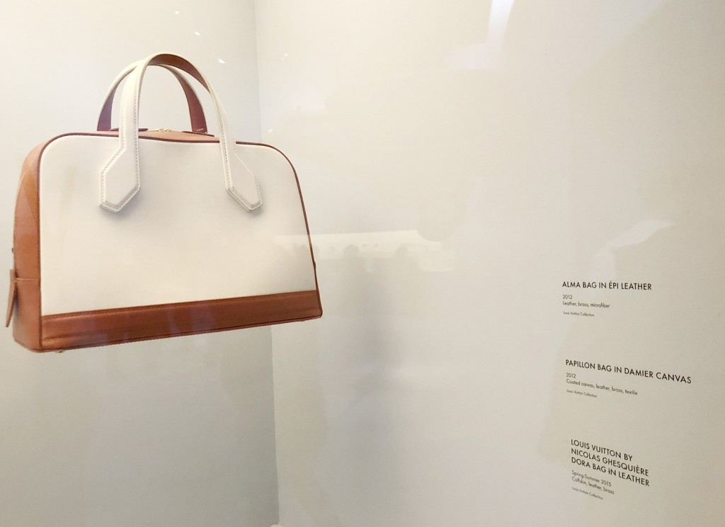 Vintage handbag with custom white decals for exhibit labels and artwork description.