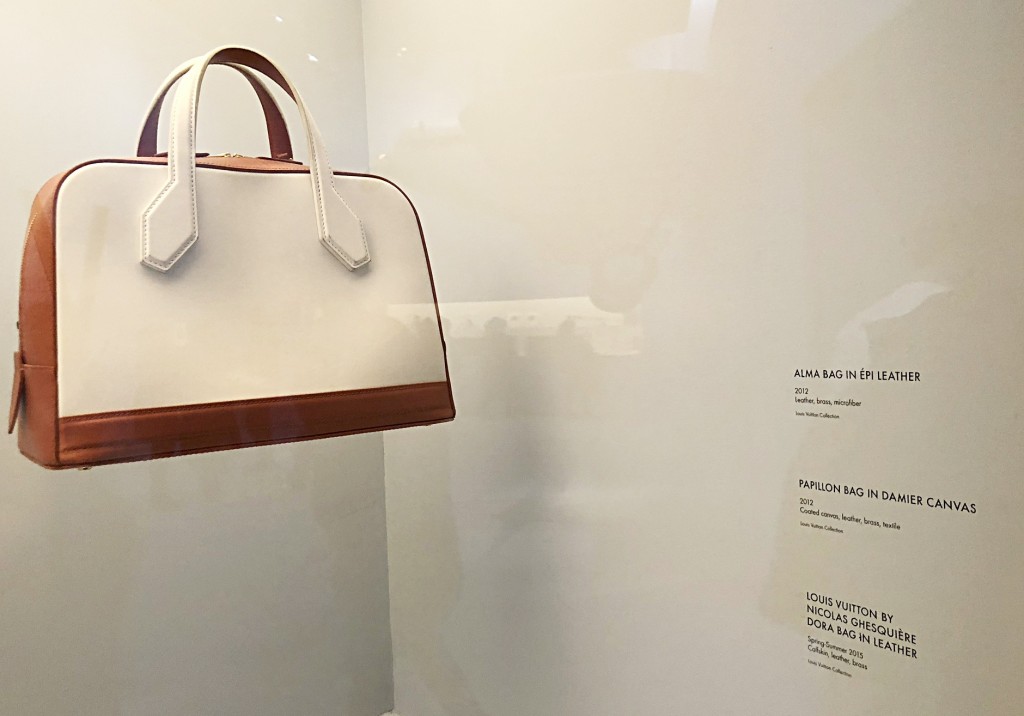 Vintage handbag with custom white decals for exhibit labels and artwork description.