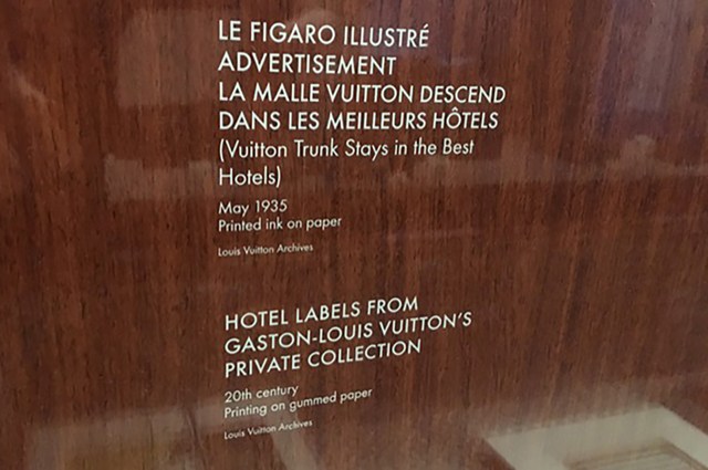 A white transfer decal mounted on glass made using custom dry transfers for museum labels